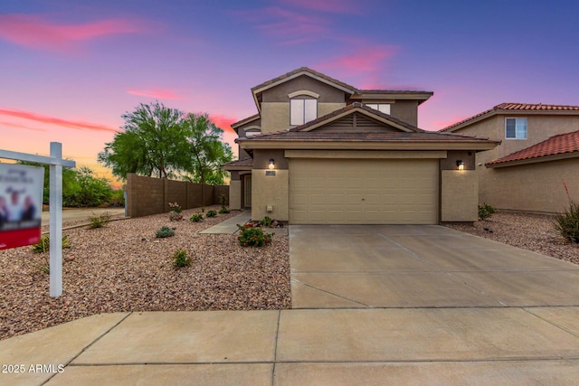 864 S 223rd Ln, Buckeye, AZ 85326 - view of front of property featuring driveway, an attached garage, stucco siding, and a tiled roof