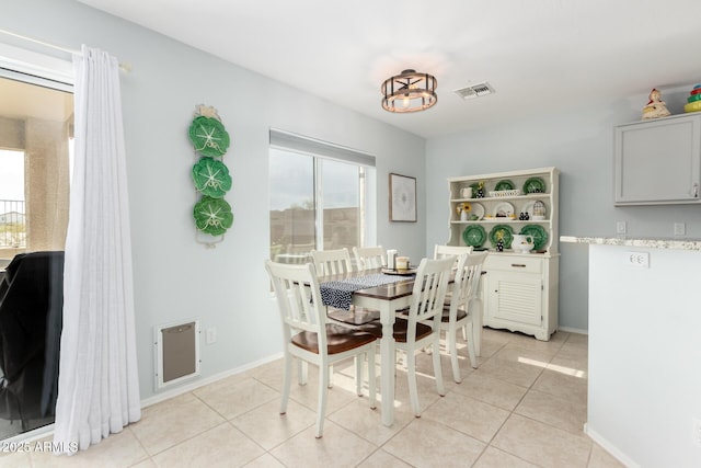 864 S 223rd Ln, Buckeye, AZ 85326 - dining space featuring plenty of natural light, light tile patterned flooring, and baseboards