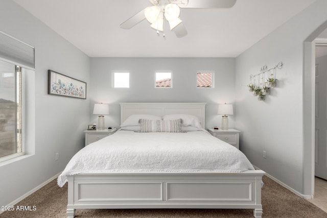 864 S 223rd Ln, Buckeye, AZ 85326 - bedroom featuring carpet floors, baseboards, a ceiling fan, and arched walkways