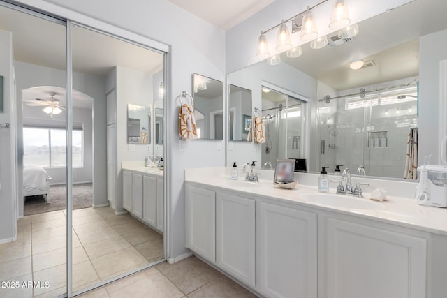 864 S 223rd Ln, Buckeye, AZ 85326 - ensuite bathroom with ceiling fan, double vanity, a stall shower, and tile patterned floors