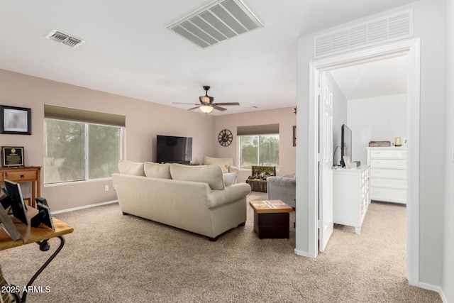 864 S 223rd Ln, Buckeye, AZ 85326 - living room with light carpet, baseboards, and ceiling fan
