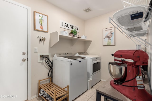 864 S 223rd Ln, Buckeye, AZ 85326 - laundry area featuring washing machine and clothes dryer, light tile patterned floors, and baseboards