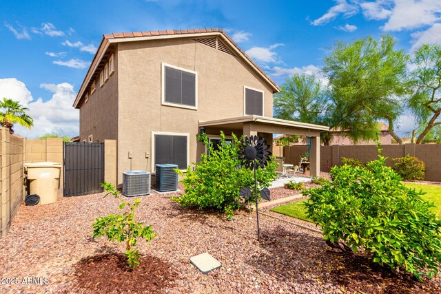 864 S 223rd Ln, Buckeye, AZ 85326 - rear view of property featuring stucco siding, a patio area, a fenced backyard, and central AC unit
