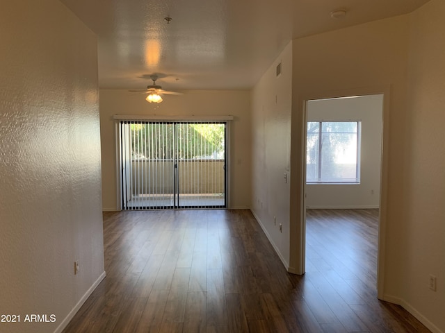 6770 N 47th Ave Unit 1022, Glendale, AZ 85301 - unfurnished room featuring a ceiling fan, dark wood-type flooring, healthy amount of natural light, and baseboards