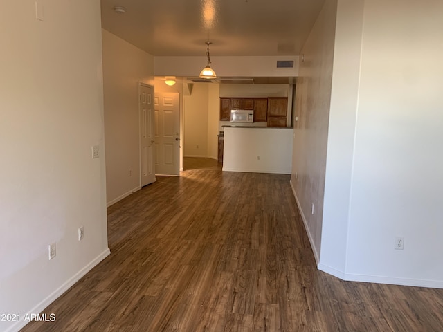 6770 N 47th Ave Unit 1022, Glendale, AZ 85301 - unfurnished living room featuring dark wood finished floors and baseboards