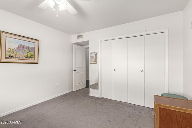 unfurnished bedroom with ceiling fan, a closet, and light carpet