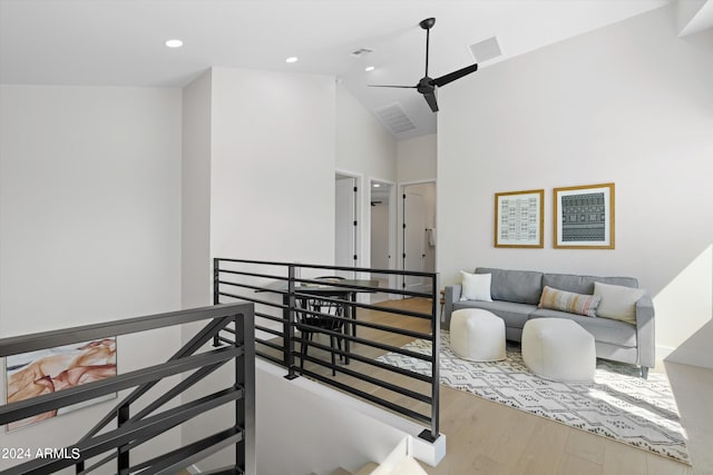 living room with ceiling fan, high vaulted ceiling, and hardwood / wood-style flooring