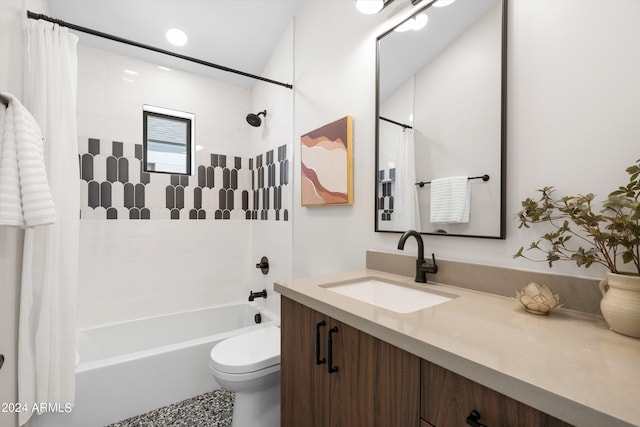 full bathroom with vanity, shower / bath combo, and toilet