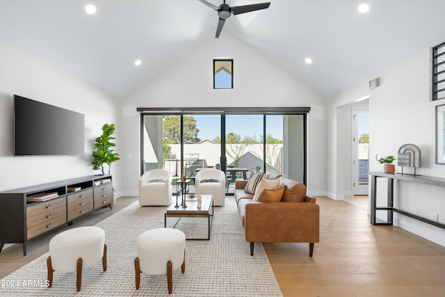 living room featuring light wood-type flooring, high vaulted ceiling, and ceiling fan