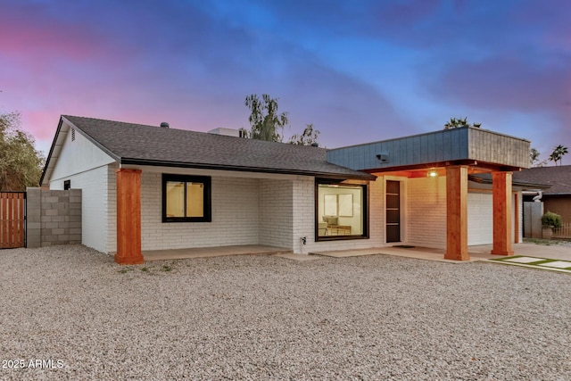2905 W Campo Bello Dr, Phoenix, AZ 85053 - view of front of home featuring an attached garage, a shingled roof, fence, and brick siding
