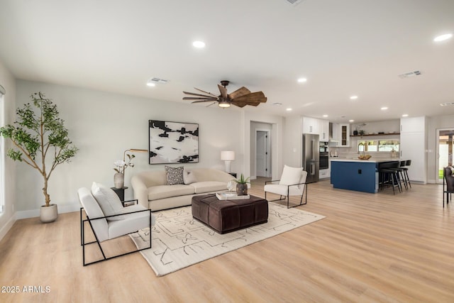 2905 W Campo Bello Dr, Phoenix, AZ 85053 - living room with ceiling fan, recessed lighting, light wood-style flooring, and visible vents