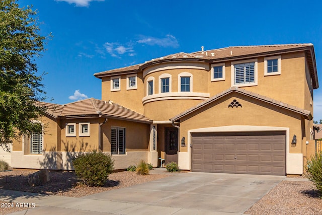 mediterranean / spanish-style home featuring a garage