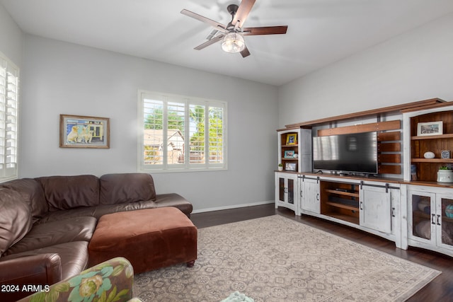 living room featuring dark hardwood / wood-style flooring and ceiling fan