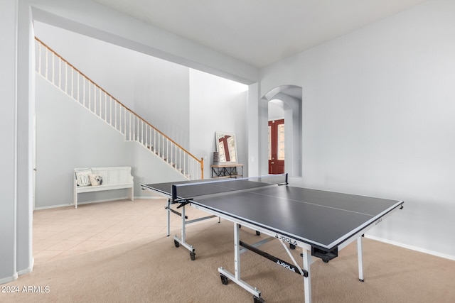 recreation room featuring light colored carpet