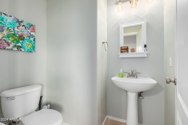 bathroom featuring tile patterned flooring and toilet