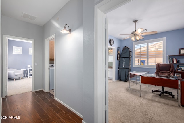 home office featuring dark wood-type flooring and ceiling fan