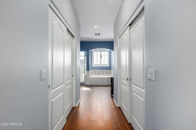 hallway with dark hardwood / wood-style flooring