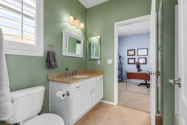 bathroom featuring vanity, tile patterned flooring, and toilet