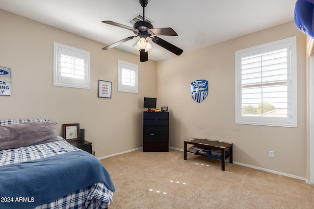 bedroom featuring light colored carpet and ceiling fan