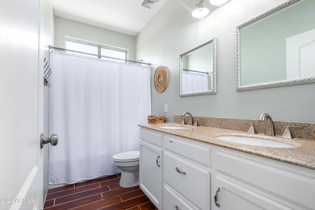 bathroom featuring a shower with curtain, hardwood / wood-style flooring, vanity, and toilet