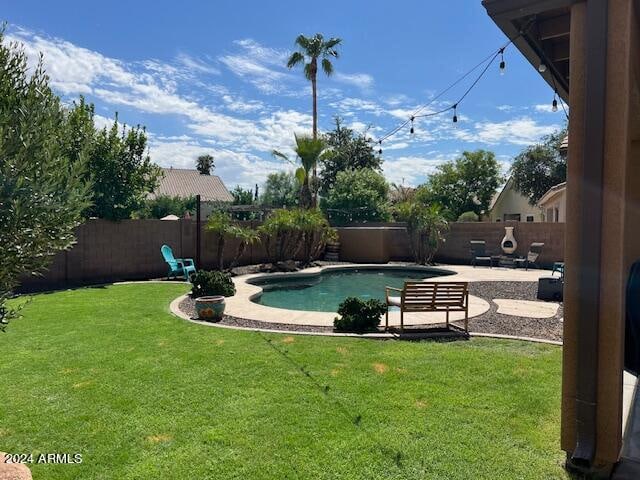 view of pool with a yard and a patio area