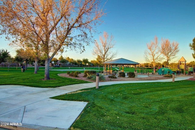 view of community featuring a playground, a yard, and a gazebo