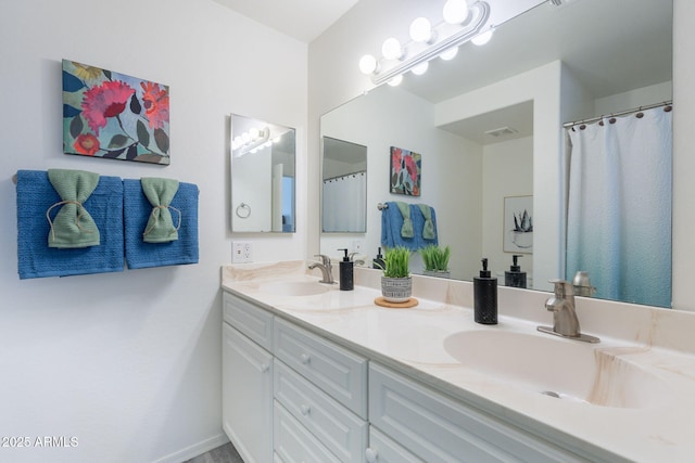 full bath featuring a sink, double vanity, and visible vents