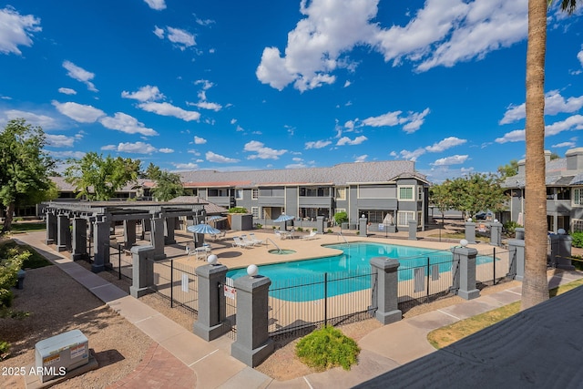 pool with a patio and fence