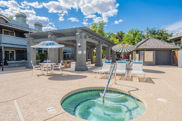 view of swimming pool with a patio and a community hot tub