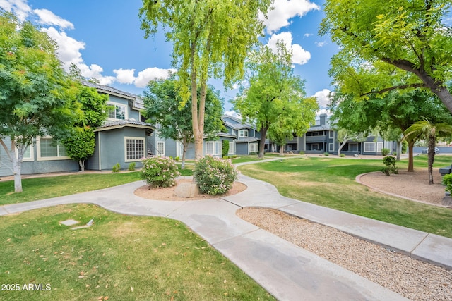 view of property's community with a lawn