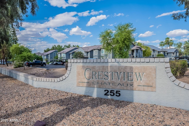 community / neighborhood sign with a residential view