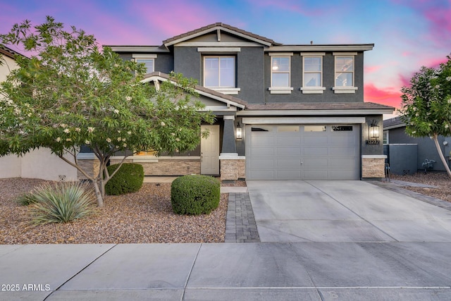 13237 W Redstone Dr, Peoria, AZ 85383 - view of front of house featuring concrete driveway, an attached garage, stucco siding, and stone siding