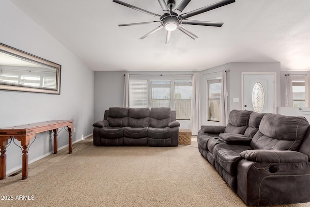 living area featuring plenty of natural light, baseboards, a ceiling fan, and carpet floors