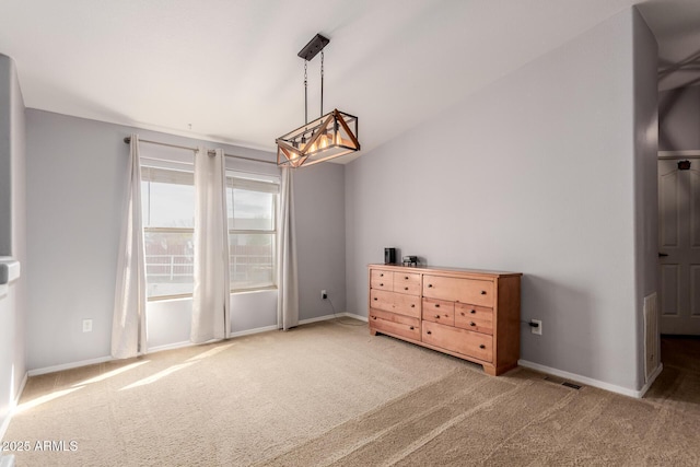 interior space featuring baseboards, carpet floors, and lofted ceiling