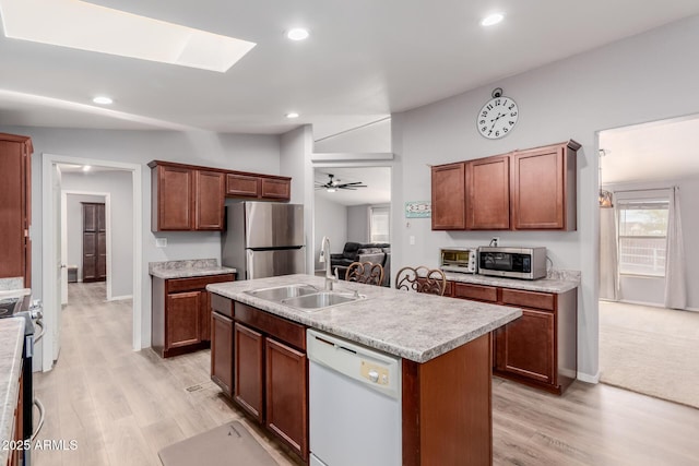 kitchen with light countertops, recessed lighting, appliances with stainless steel finishes, and a sink