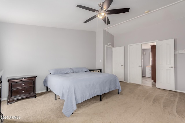 bedroom featuring visible vents, baseboards, light colored carpet, ceiling fan, and vaulted ceiling