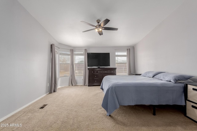 bedroom with multiple windows, baseboards, visible vents, and light carpet