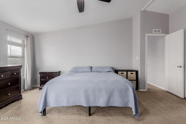 bedroom with visible vents, baseboards, light colored carpet, and a ceiling fan