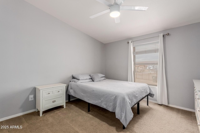 bedroom featuring baseboards, light colored carpet, and ceiling fan