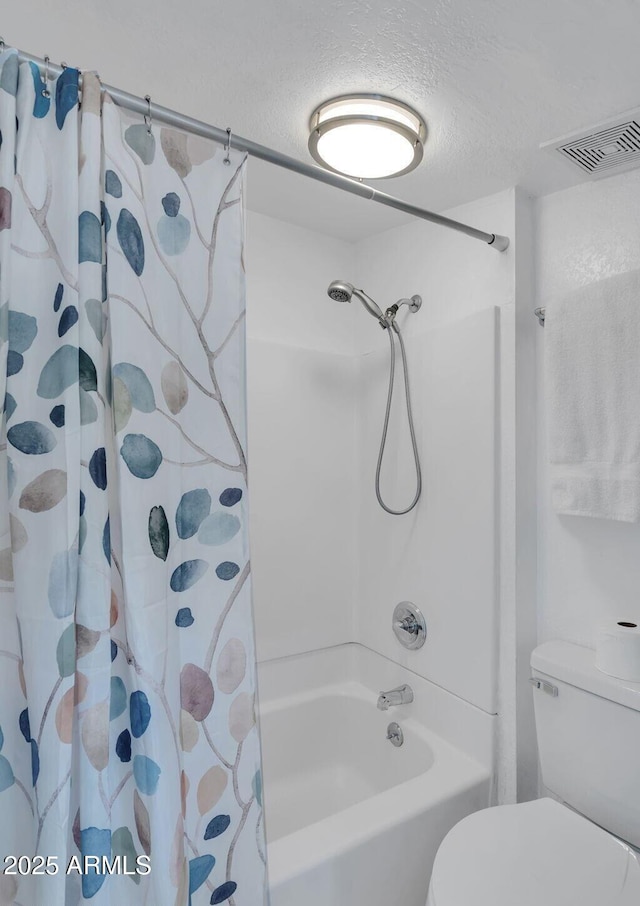 bathroom featuring shower / tub combo, visible vents, a textured ceiling, and toilet