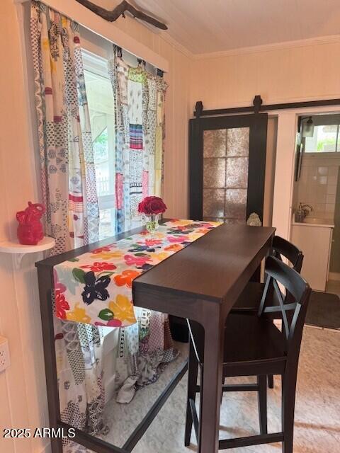 dining space featuring crown molding