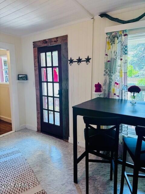 dining area with baseboards, ornamental molding, wood ceiling, and a healthy amount of sunlight