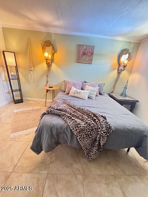 bedroom featuring ornamental molding and baseboards