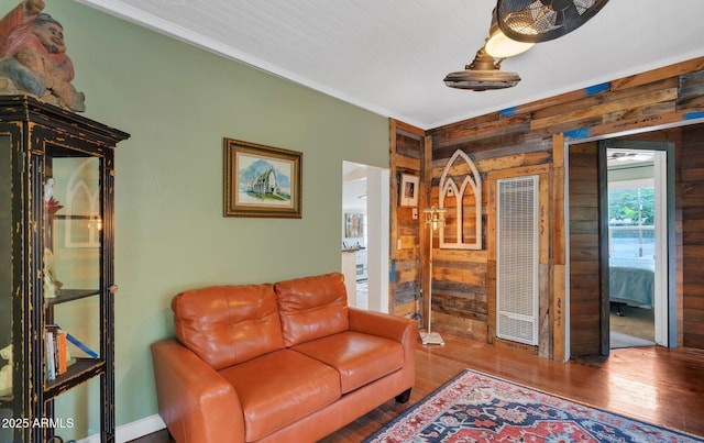living room with wood finished floors and wooden walls