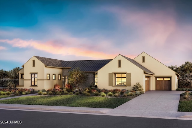 view of front of house featuring a yard and a garage