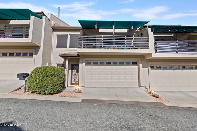 townhome / multi-family property with a balcony and a garage