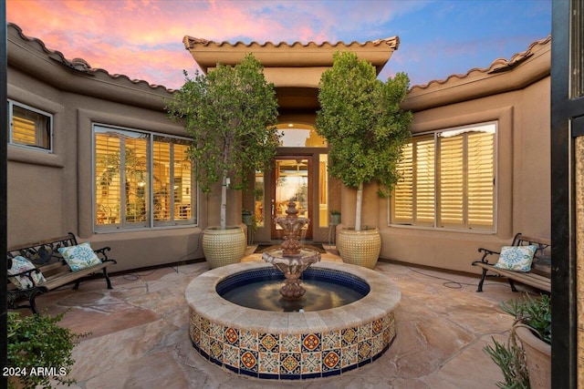 view of patio terrace at dusk