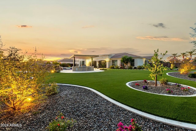 yard at dusk with a patio