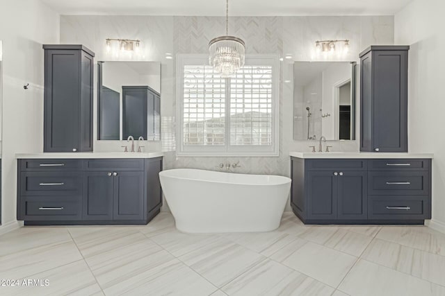 bathroom featuring tile patterned flooring, vanity, tile walls, a bath, and a chandelier