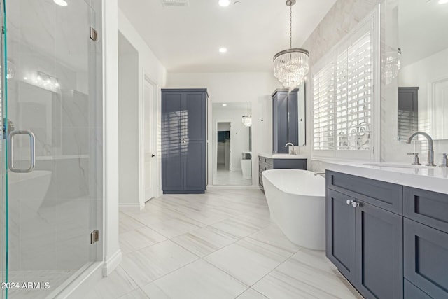 bathroom featuring an inviting chandelier, separate shower and tub, and vanity